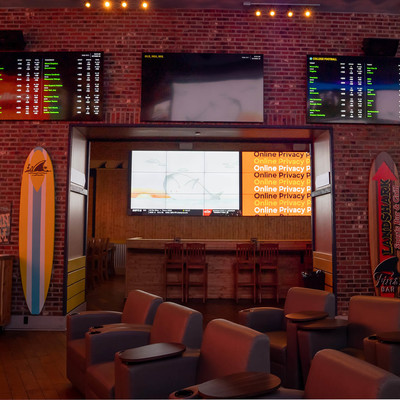 Recliners with TVs showing various sports information