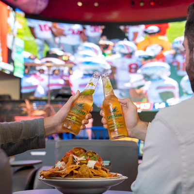 Two friends enjoying Landshark lagers while watching a football game