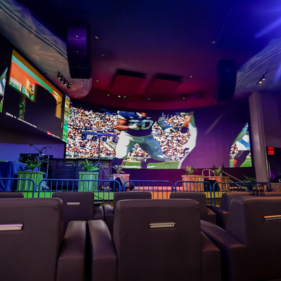 Seating area with recliners and multiple tvs for viewing sports games