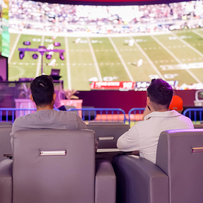 Two friends relaxing in recliners while watching football