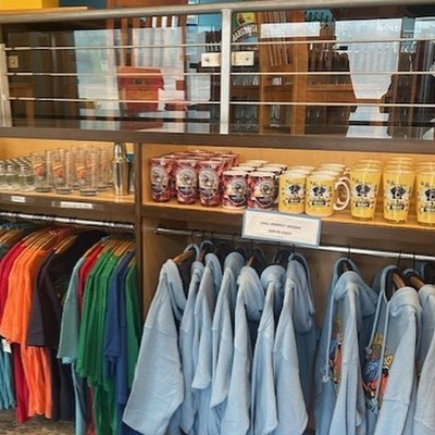 Display of Margaritaville hoodies, shirts, and branded souvenir mugs