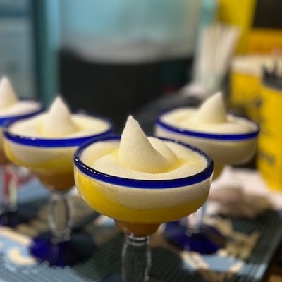 Photo of yellow margarita cocktails with salted rims and lemon garnishes