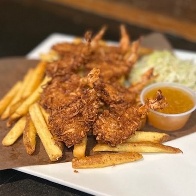 Photo of crispy fried shrimp served with french fries and dipping sauce
