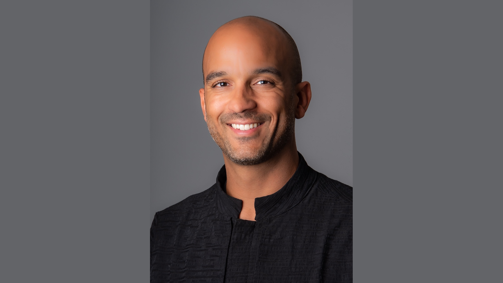 Head shot of a man wearing a black shirt