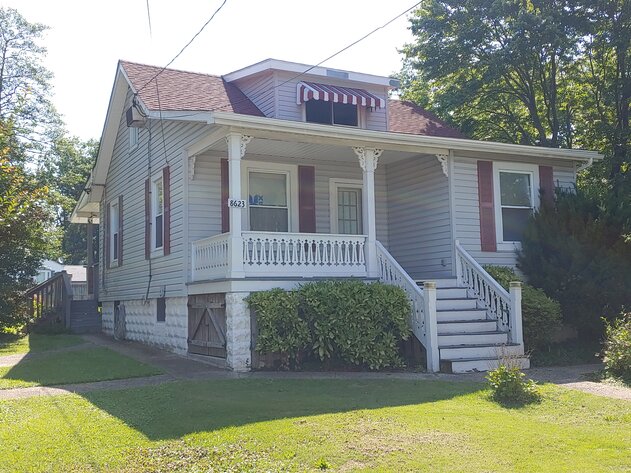 CLEAN VINYL SIDED CAPE COD W/ LARGE DETACHED 2-BAY GARAGE W/ HEAT & AIR ON 0.56+/- ACRES