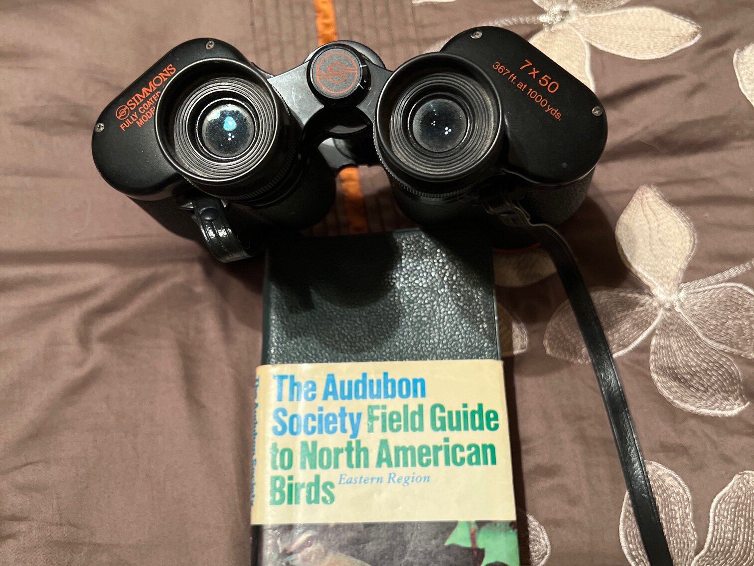 Simmons 7 x 50 binoculars and North American bird book
