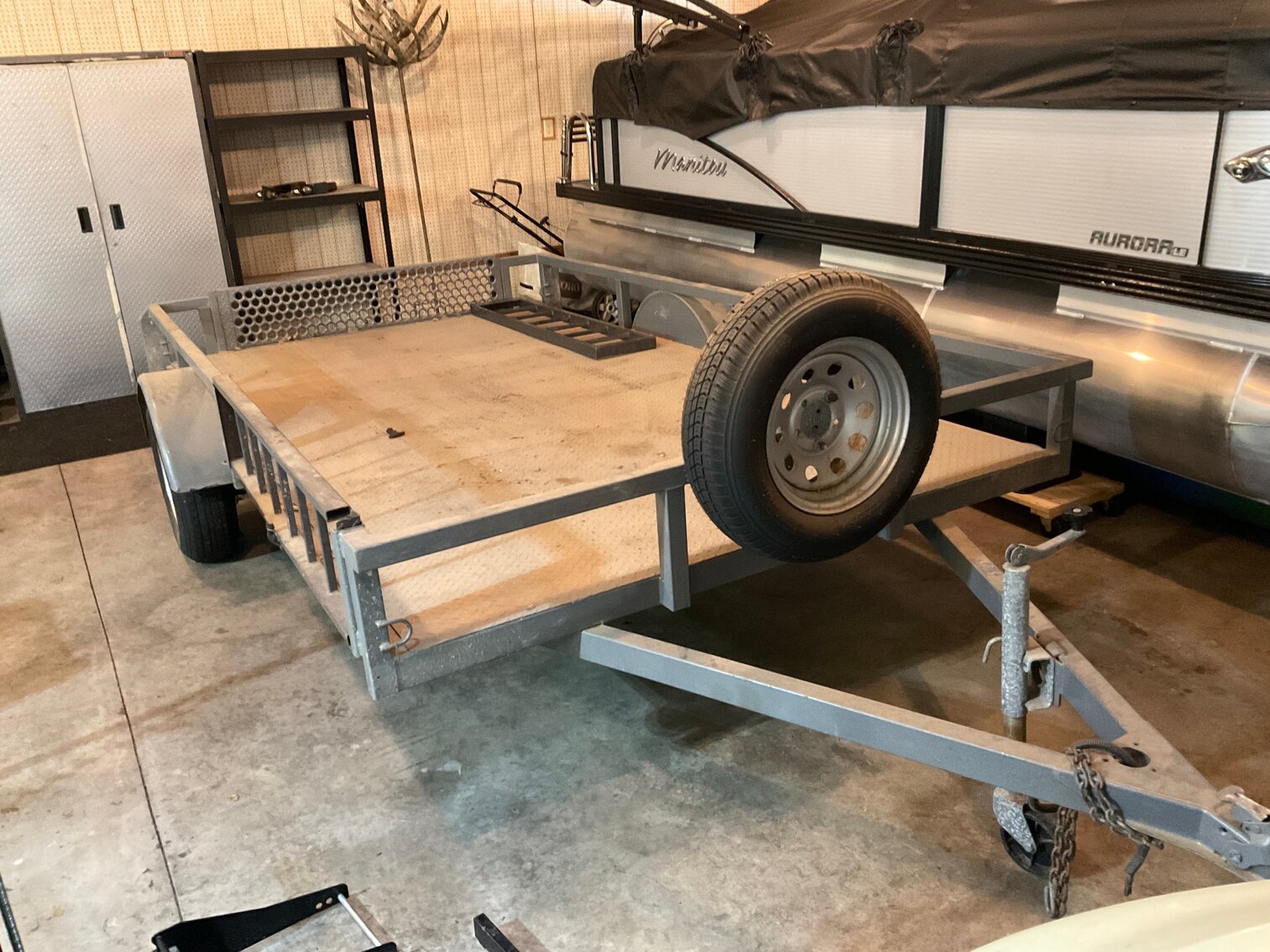 Utility trailer with diamond plate deck, includes ramps and spare tire