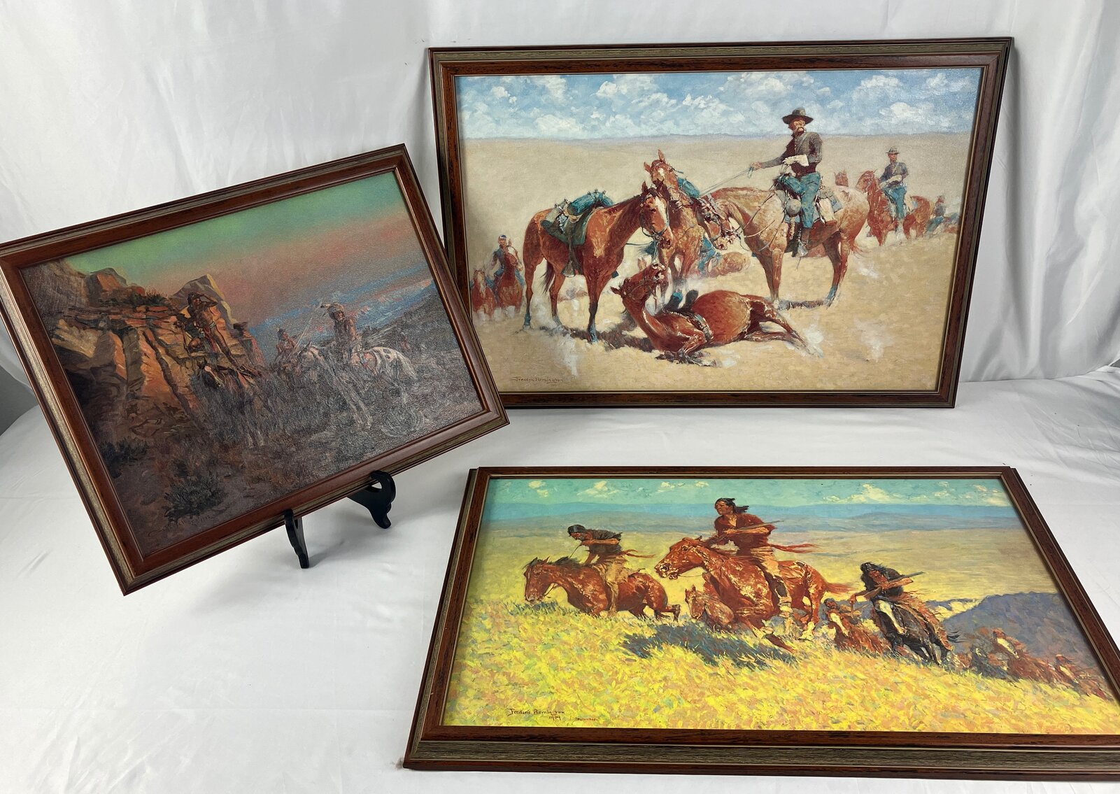 Three Framed Prints on Canvas of Paintings by Remington and Russell