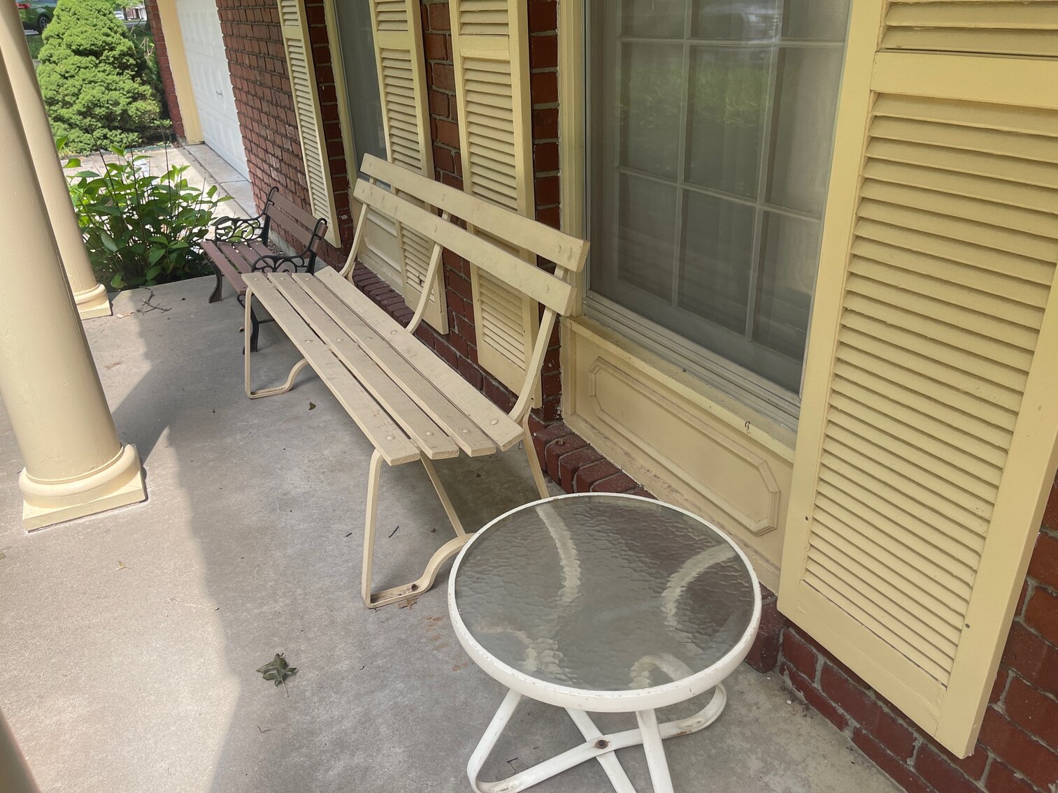 Benches and small table on front porch