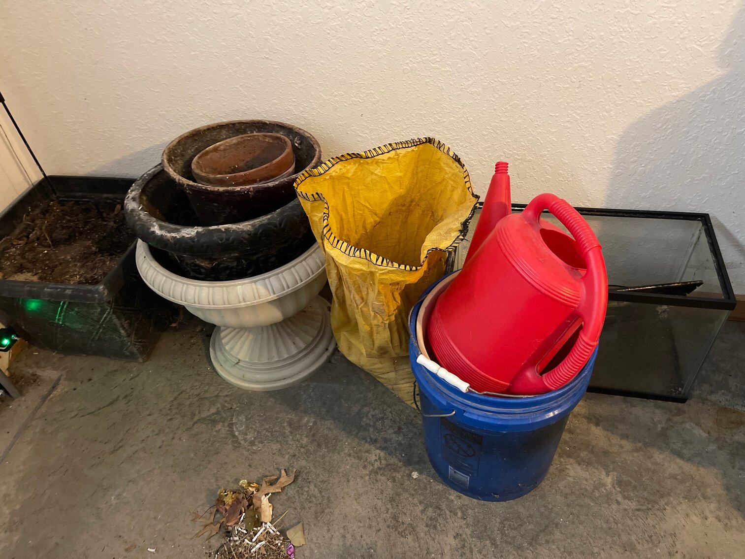 Flower pots, buckets, bag of sand, aquarium