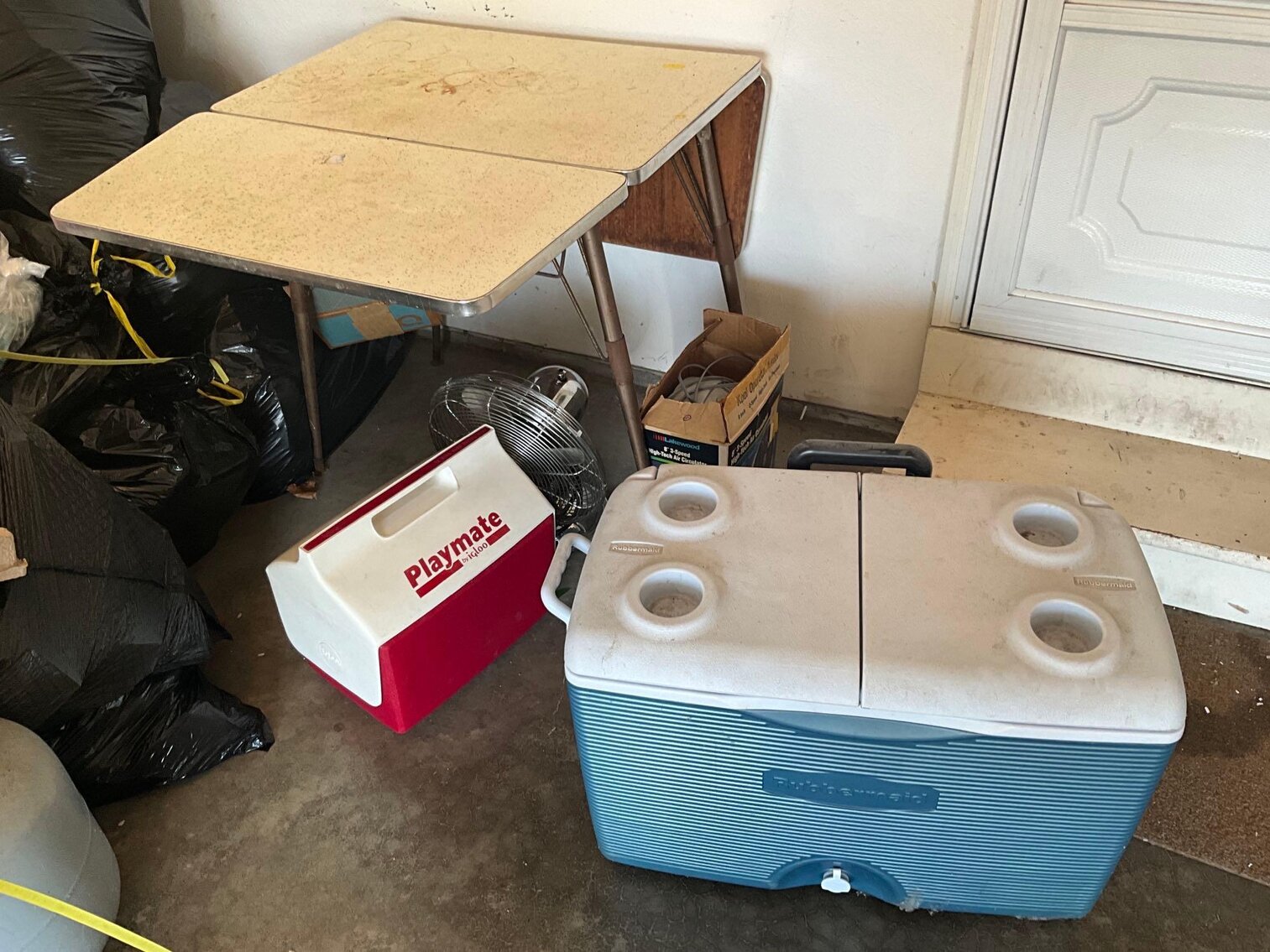 Garage (G)- (2) Coolers, Table, and (2) Fans