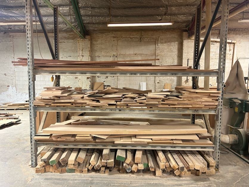 Gray pallet rack and contents of wood scraps