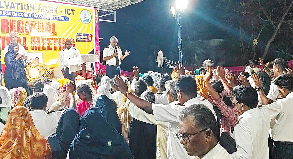 The Salvation Army congregation gathering in prayer during a spiritual revival meeting