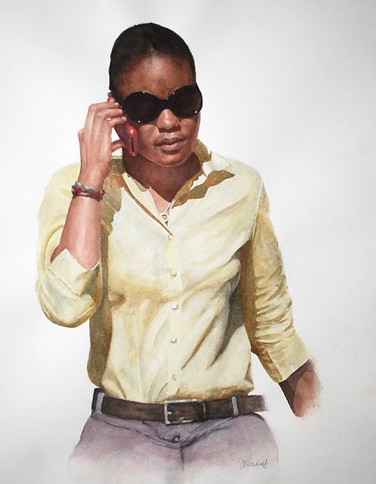 Black woman in a yellow shirt with dark sunglasses talking on cellphone