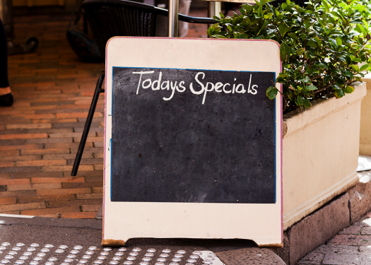 Outdoor menu board with restaurant specials that may include food trends
