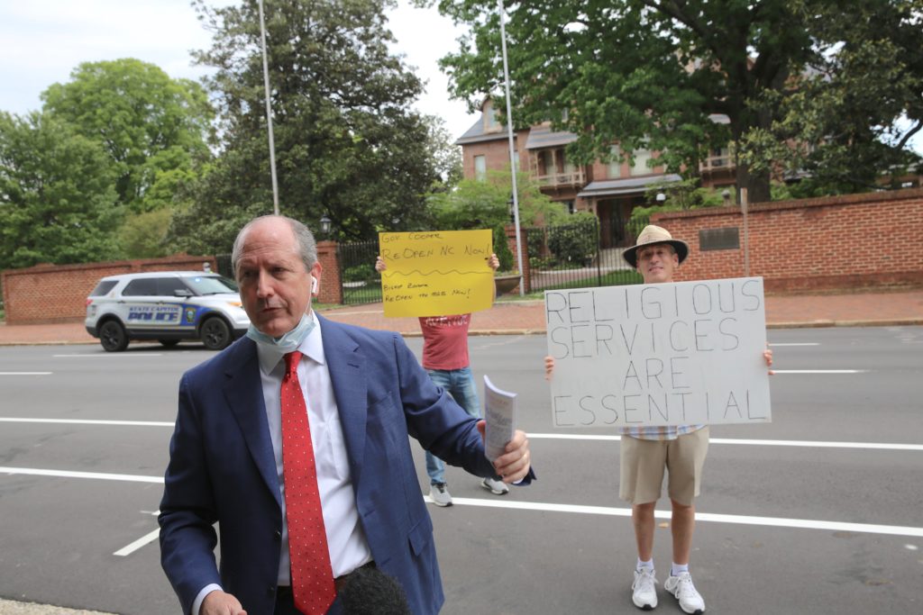 Attending a ReopenNC protest, U.S. Rep. Dan Bishop, R-9th District, prepares to deliver a copy of the U.S. Constitution to the Executive Mansion April 21. (CJ photo by Don Carrington)