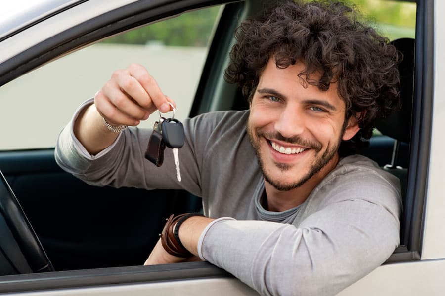 Man Smiling Holds Key