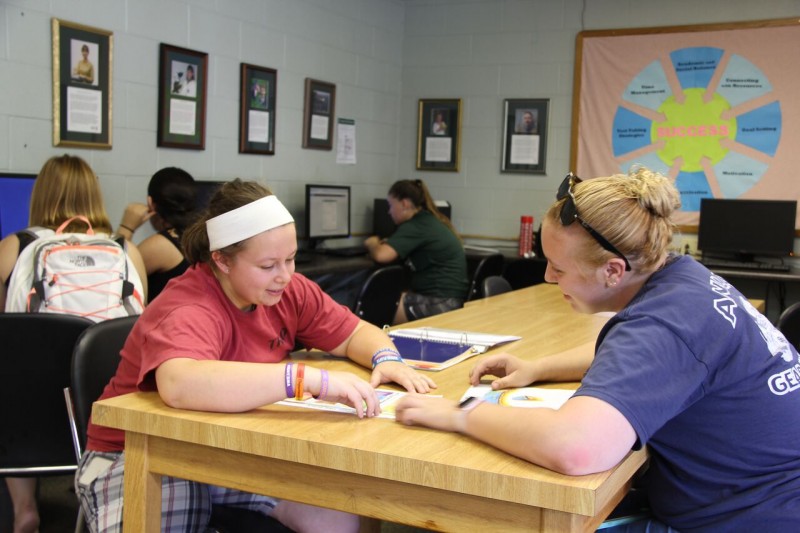 Peer tutor with student
