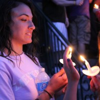 A student lights her candle.