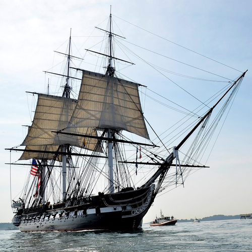 Sailing Ship Cutting Through Waves Cover Art Blurred Background