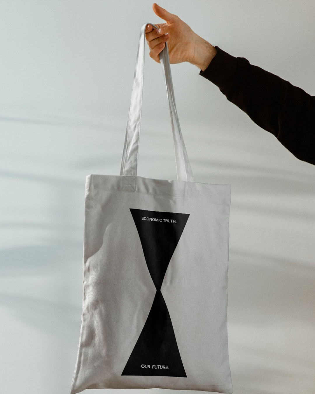 Adamant tote bag mock-up with hourglass symbol.