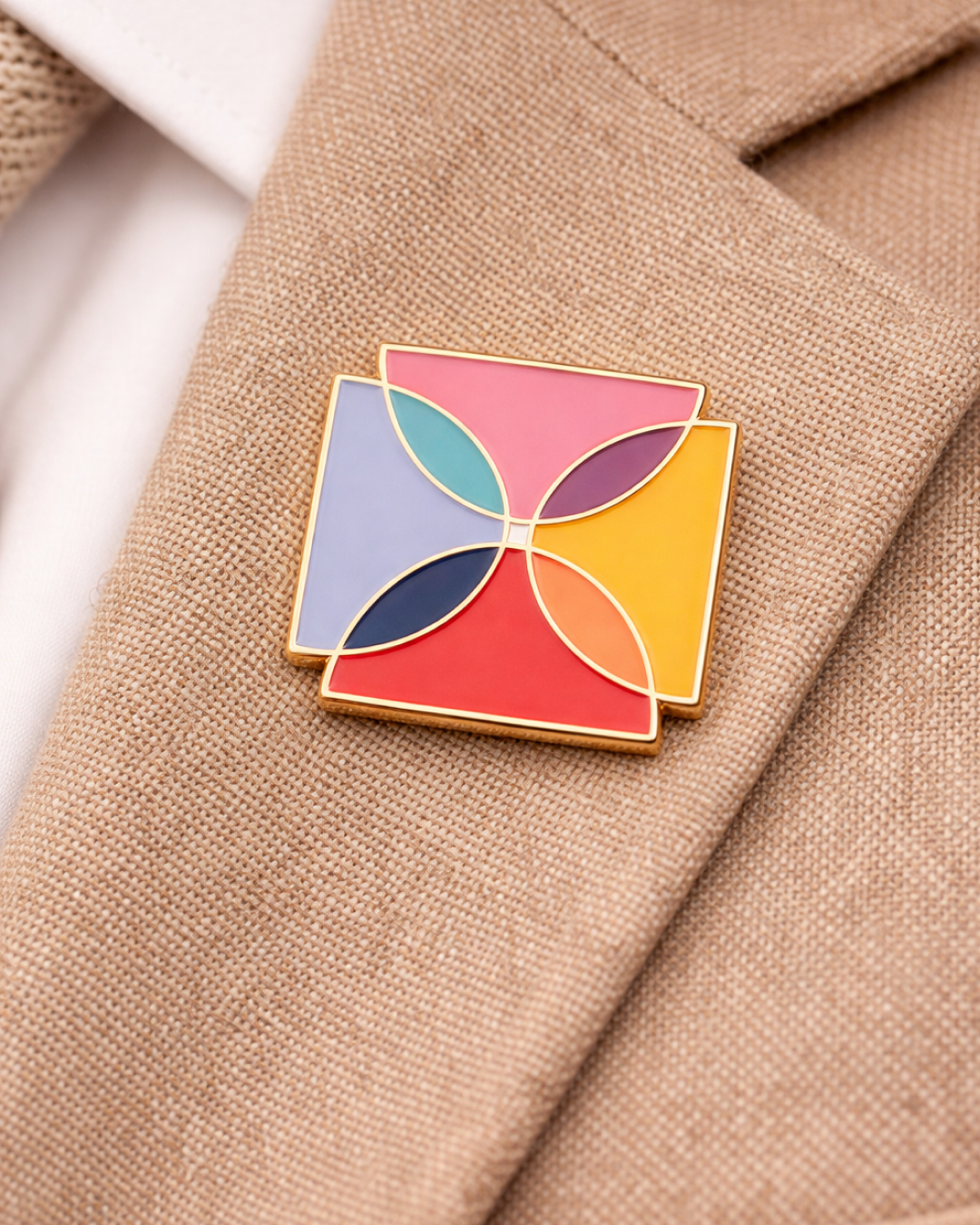 Colourful Alzheimer’s & Dementia Foundation logo pin attached to the lapel of a beige jacket.