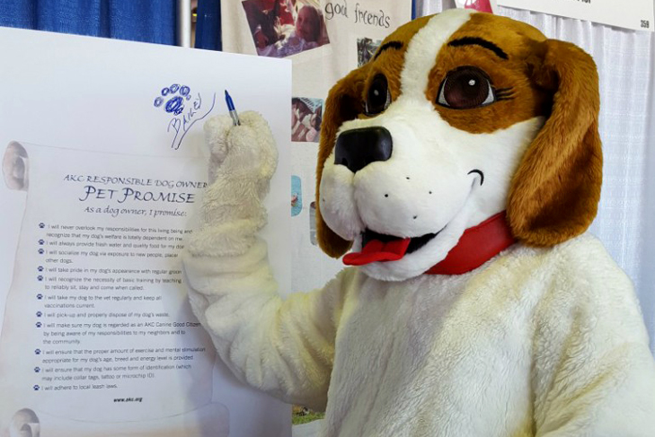 Bailey the mascot signs the Responsible Dog Ownership pet promise