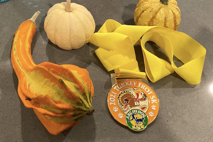 turkey trot medal on a table with three gourds