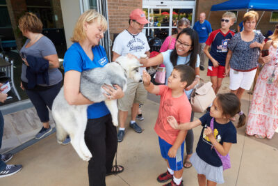 Puppy being shown to children at event