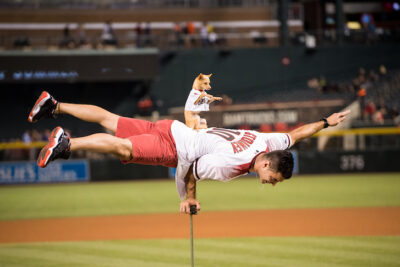 Christian Stoinev and his pet Scooby perform prior to throwing out the first pitch at an Arizona Diamondbacks game at Chase Field on September 14, 2016 in Phoenix, Arizona.