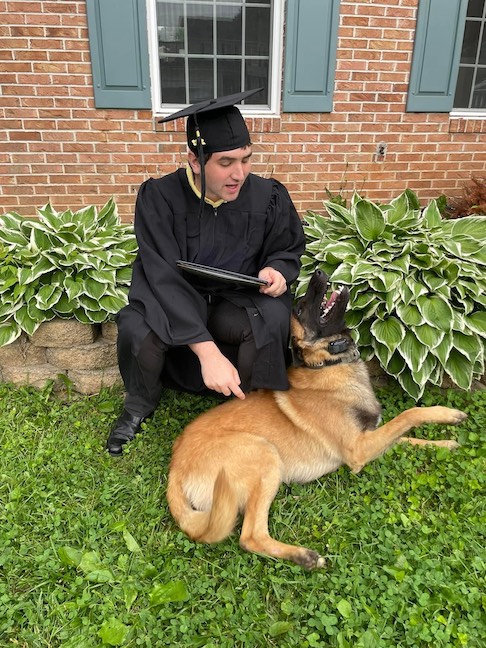Wooton and his a Belgian Malinois, Lynyrd, on high school graduation day.