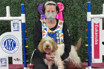 Woman and dog at agility competition