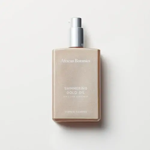 AB_Shimmering_Gold_Oil_1_Big | BEAUTIFY.TIPS Bottle of african botanics shimmering gold oil on a white background.