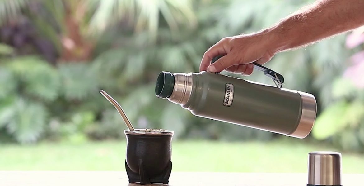 Foto de termo Stanley y una persona cebando mate al aire libre