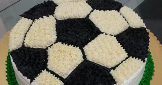 Primer plano de pastel soccer: rosetas blancas y negras formando un balón