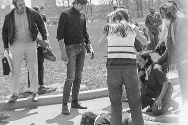 Upset students surround a victim of the Kent State shooting.