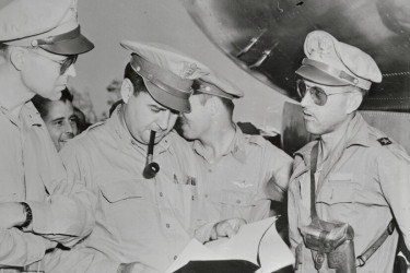 Curtis LeMay holding plans for the bombing of Tokyo.