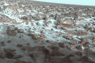 This false-color photo of the surface of Mars was taken by Viking Lander 2 at its Utopia Planitia landing site on May 18, 1979. It shows a thin coating of water ice on the rocks and soil.