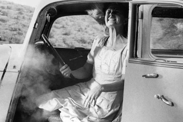 Still frame from a slow motion sequence in the 1967 film Bonnie and Clyde shows actress grimacing inside a vehicle.