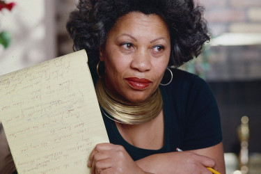 Toni Morrison holding a manuscript.