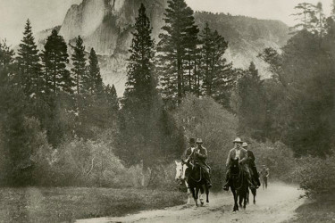 Teddy Roosevelt and John Muir ride horses in Yosemite.