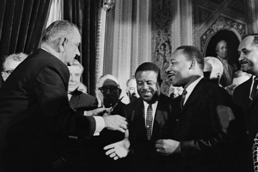 President Johnson shaking hands with Martin Luther King Jr