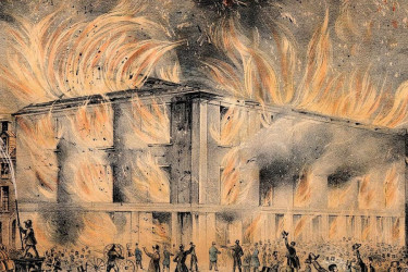 Pennsylvania Hall in flames as a crowd watches and firefighters work.