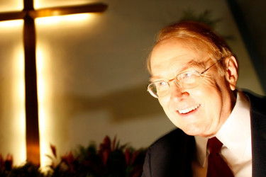 James Dobson in front of a cross.