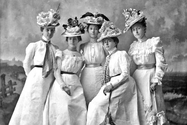 Women from the 1890s wearing white dresses.