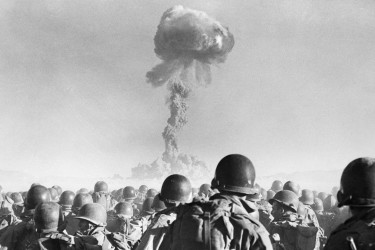 Soldiers watching a nuclear explosion.