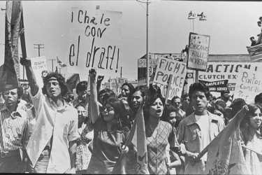 Mexican-Americans carry signs protesting the war in Vietnam.