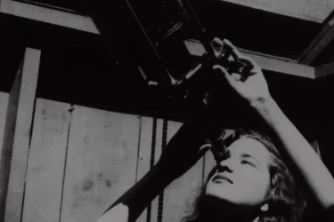 Vera Rubin and looking through a telescope.