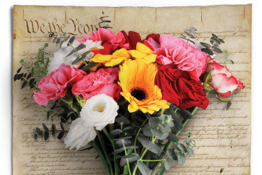 Bouquet of funerary flowers on top of the Constitution.