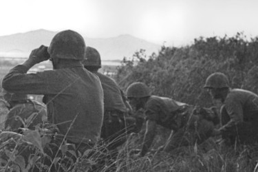 Soldiers scan the horizon in Vietnam.